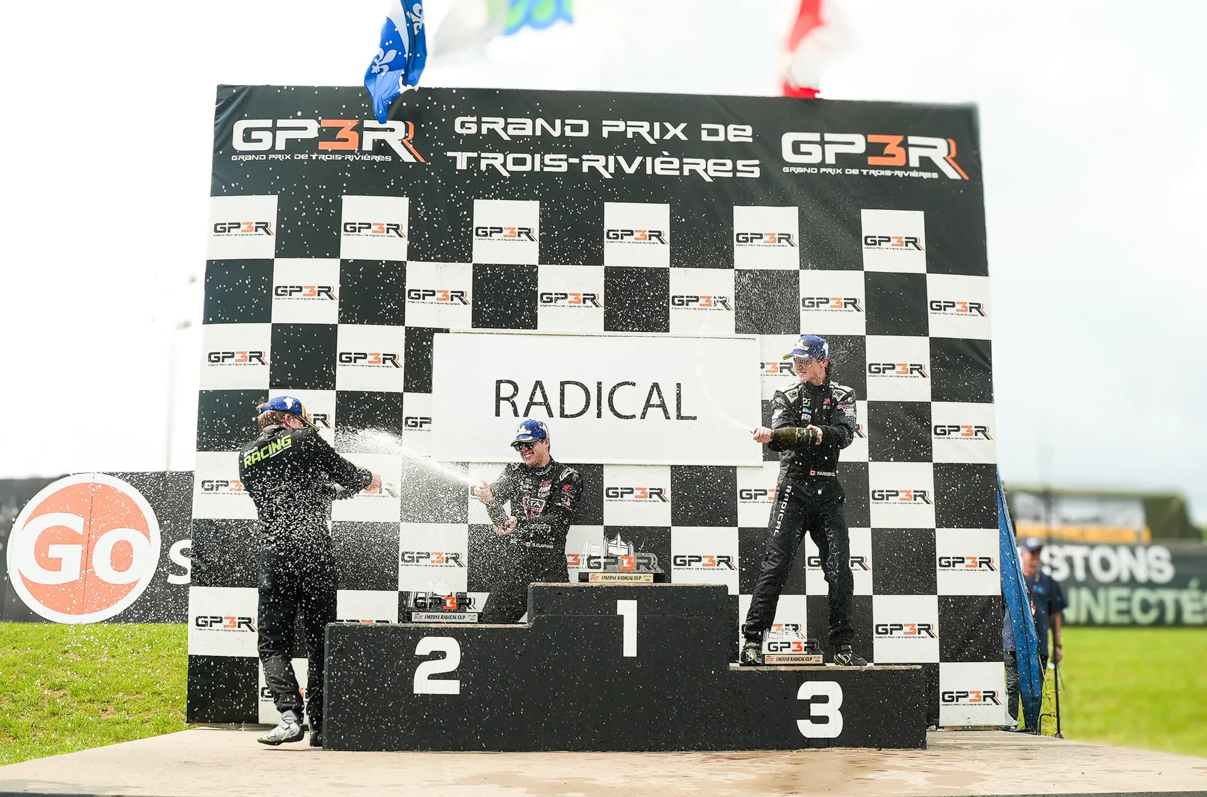 A podium celebration, bottles raised