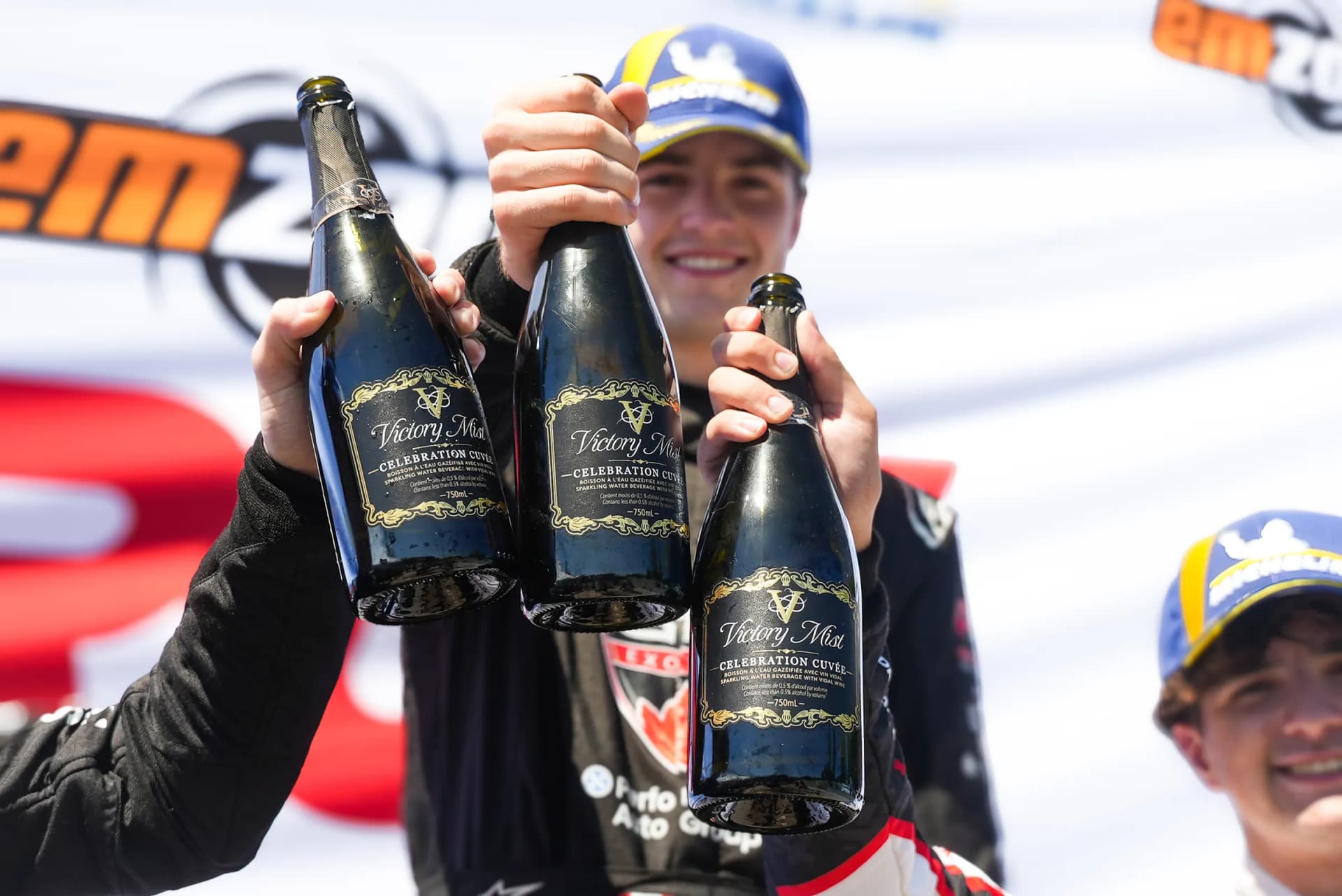 Bottles held up on the podium
